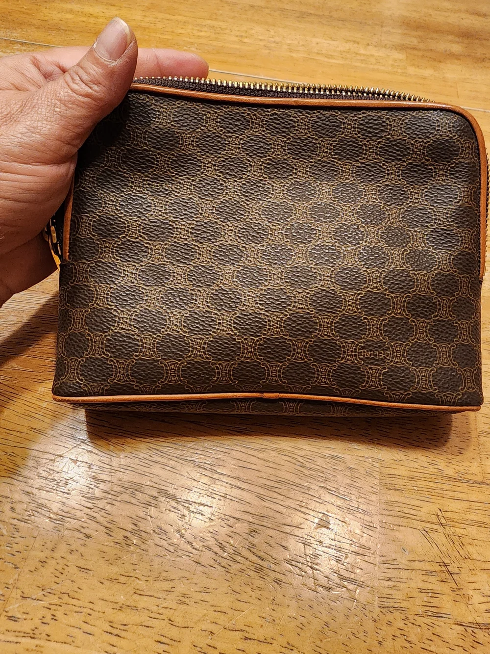 CELINE pouch is crafted from brown Triomphe canvas and features tan leather trim
